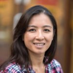 Smiling mid adult asian woman looking at the camera